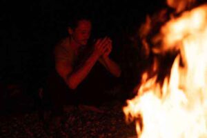 Participant drinking Wachuma medicine around the sacred fire during ceremony at Templo del Tigre in the Osa Peninsula.