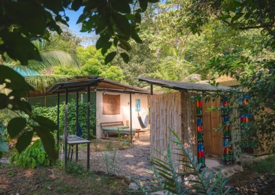 Peaceful sitting area with bath in a tropical backyard setting.