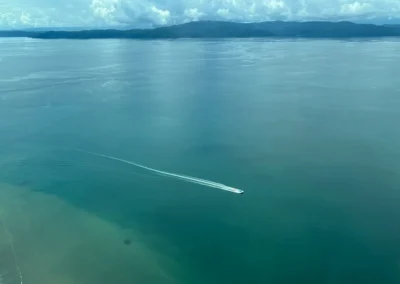 Small boat cruising on the calm waters of Golfo Dulce, Costa Rica.