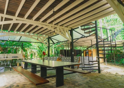 Side view of the outdoor kitchen at Templo del Tigre surrounded by lush tropical plants.