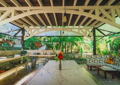 Outdoor kitchen area at Templo del Tigre surrounded by tropical greenery.