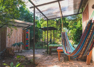 Hammock hanging in a peaceful backyard surrounded by greenery.