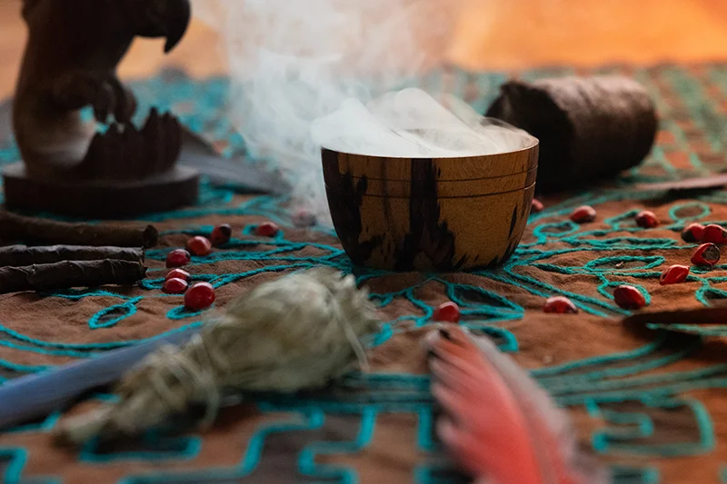 Ceremonial tobacco altar with pipe and sage smoke, part of a master plant dieta in the Osa Peninsula, Costa Rica.